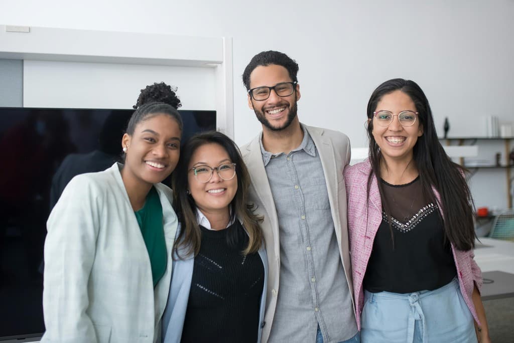 A group of professional mentors smiling together
