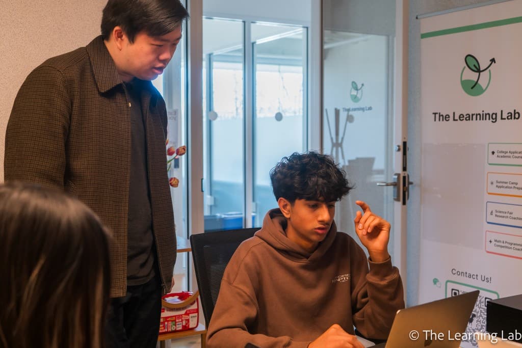 A coach guiding a student through their work